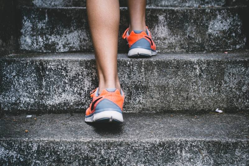 Runner climbing stairs during a morning workout